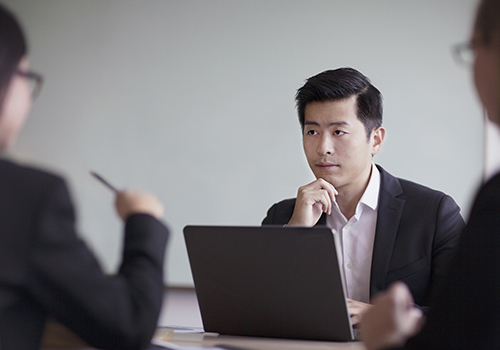 Businessman looking across table in office meeting